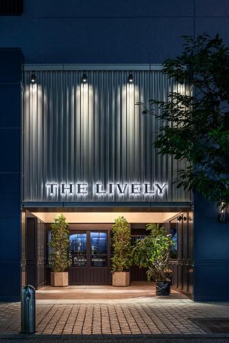 a building with a lit up sign in front of it at THE LIVELY FUKUOKA HAKATA in Fukuoka