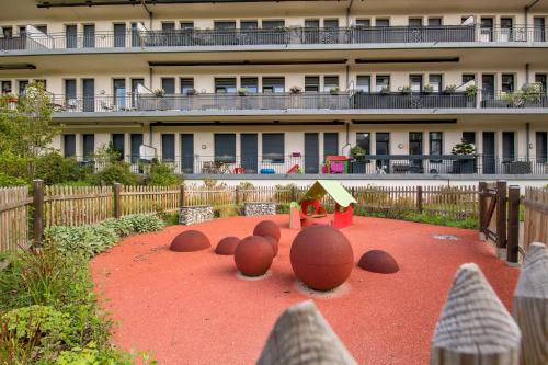 a playground in front of a large building at Résidence Pierre & Vacances La Petite Venise in Colmar