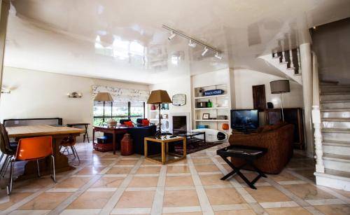 a living room with a table and a dining room at Lisbon Surf Villa in Costa da Caparica