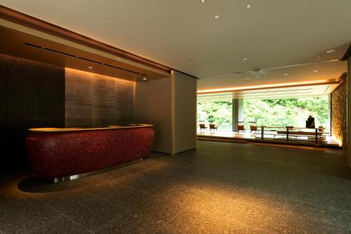 a lobby with a red bench and a large window at Chalet Ivy Jozankei in Jozankei