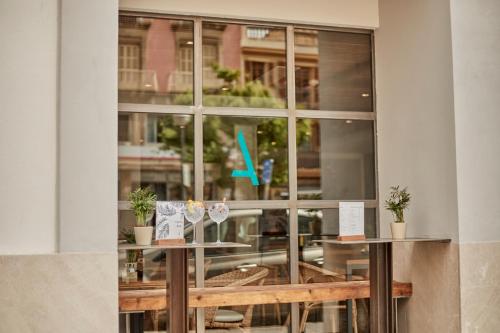 a window of a restaurant with tables and chairs at Ca n'Alexandre - Adults Only in Palma de Mallorca