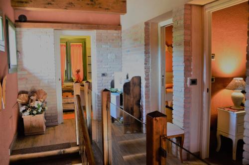 a room with a staircase and a brick wall at B&B La Piazzetta in Castiglione dei Pepoli