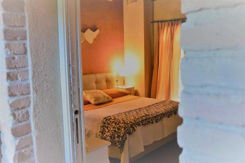 a bedroom with a bed with an orange wall at B&B La Piazzetta in Castiglione dei Pepoli