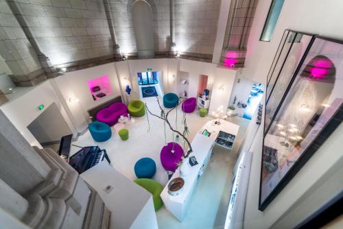 an overhead view of a living room with pink and green chairs at SOZO Hotel in Nantes