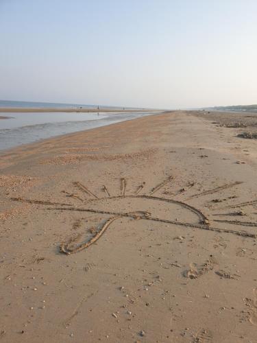 a peace sign written in the sand on a beach at Sonnevanck Wijk aan Zee in Wijk aan Zee