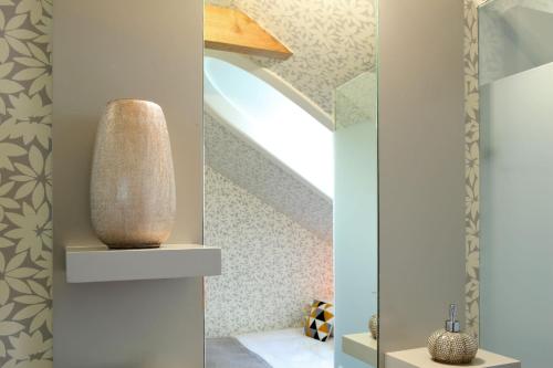 a staircase with a vase sitting on a shelf at Águamel Sintra, Boutique Guest House in Sintra