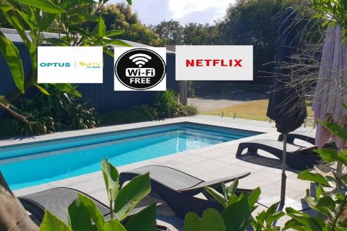 a swimming pool with signs in front of a yard at Pool to Sand in 800mtrs - Heated Pool and Pet Friendly in Rye