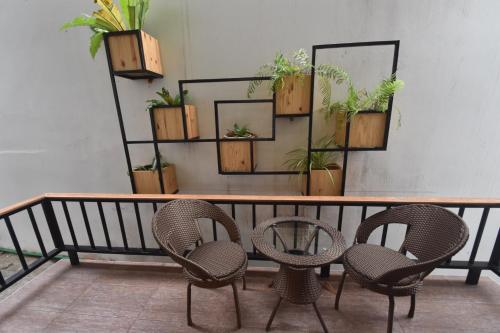 a table with chairs and plants on a wall at Simple Life Cliff View Resort in Koh Tao