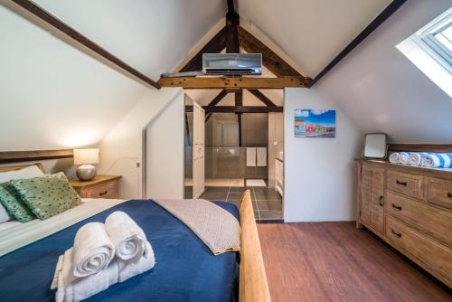 a bedroom with a bed with towels on it at Punda City Centre Penthouse in Willemstad