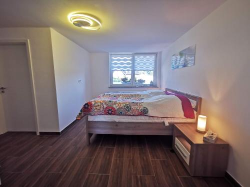 a bedroom with a bed and a window at Ferienhaus Oebel in Brüggen in Brüggen