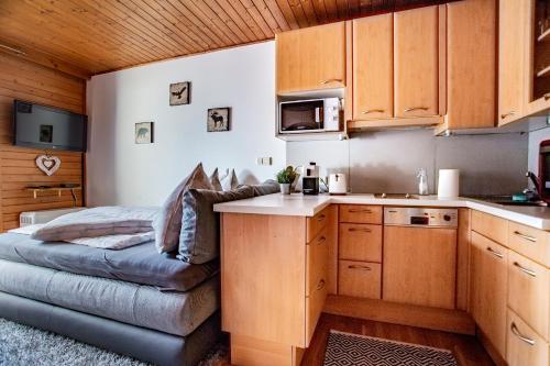 a kitchen with a couch in the corner of a room at Winzig Apartment in Schladming