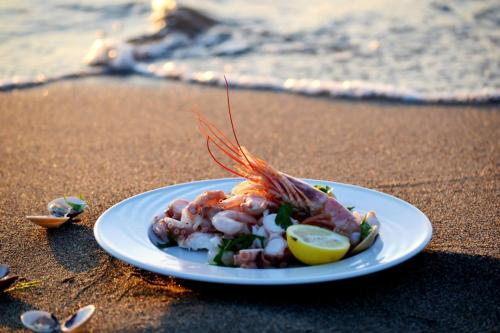 a plate of food on a sandy beach at Parco Dei Principi in Paestum