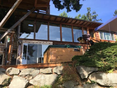 a house with large glass windows on it at Cottage Lake Bed and Breakfast in Woodinville