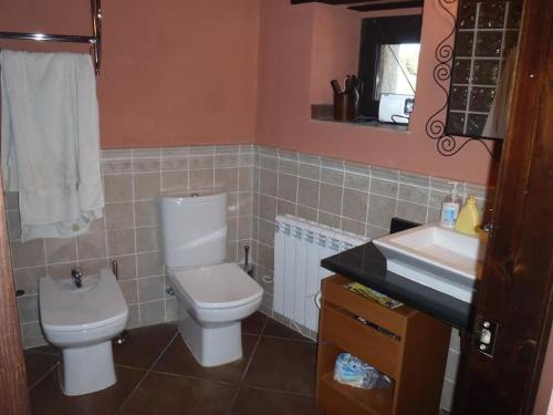 a bathroom with a toilet and a sink at CASA ARENS in Arens de Lledó