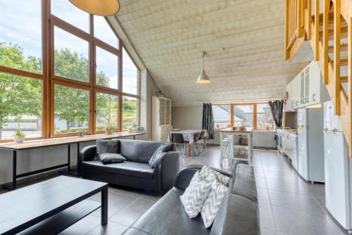 a living room with a couch and a table at Château Ferme de Laval in Sainte-Ode