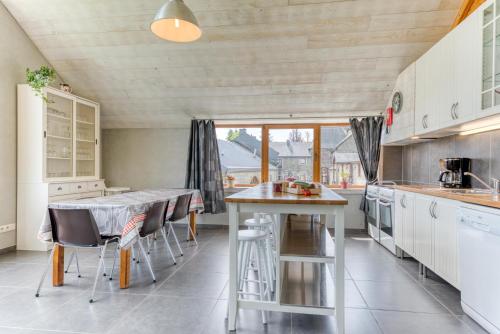 a kitchen with a table and chairs in a kitchen at Château Ferme de Laval in Sainte-Ode