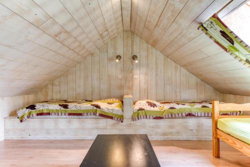 a small room with two beds in a attic at Château Ferme de Laval in Sainte-Ode