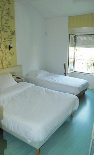 En eller flere senger på et rom på Hotel Les Passions