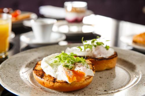a plate with two food items on a table at Mercure Bradford, Bankfield Hotel in Bradford