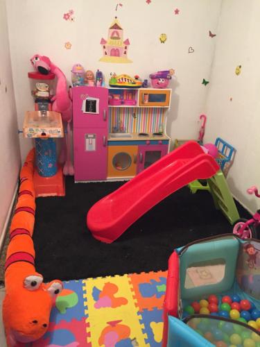 a childs play room with a slide and toys at Villa Miranda in Carrascal de Barregas
