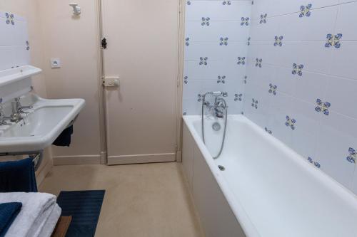 a bathroom with a tub and a sink at La Buffonnerie in Moutiers-Saint-Jean