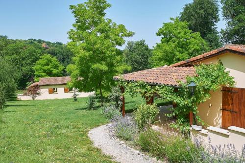 a garden with a building with a gazebo at Village de Montmarsis in Gourdon-en-quercy
