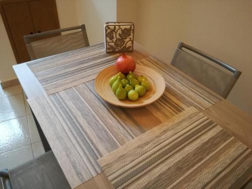a bowl of fruit on a table with a plate of grapes at Casa Amata Salentina in Squinzano