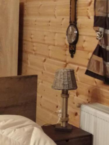 a lamp sitting on a table next to a bed at Kedra Village in Kédra
