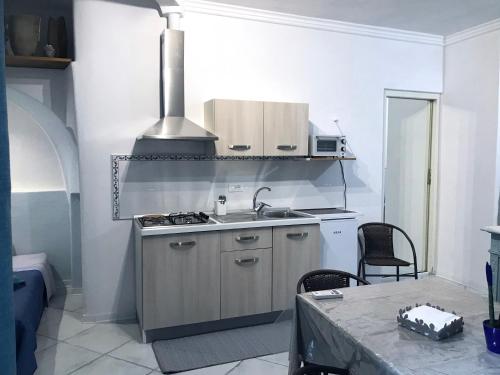 a kitchen with a sink and a stove at TAVERNETTA SUL PORTO in Ischia