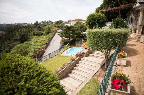 a stairway leading up to a swimming pool at ESPIGUEIRO DA CASADA VILLA RURAL - FOZ DO DOURO by LW in Foz do Sousa