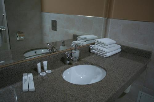 a bathroom counter with a sink and a mirror at Hotel Aner in Astana