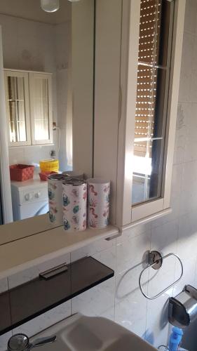 ein Badezimmer mit einem Waschbecken, einem Spiegel und einer Theke in der Unterkunft La casa di Ulisse 008055- LT0806 in Sanremo