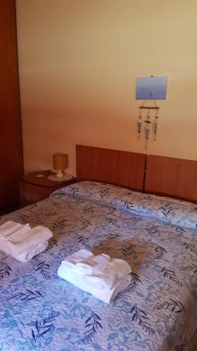 a bedroom with a bed with two towels on it at La casa di Ulisse 008055- LT0806 in Sanremo