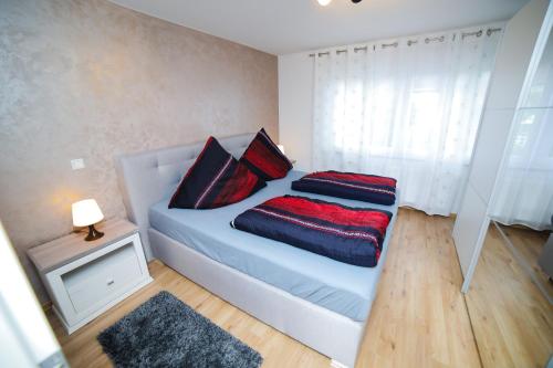 a bed with two pillows on it in a room at Apartment Claudia in Sinsheim
