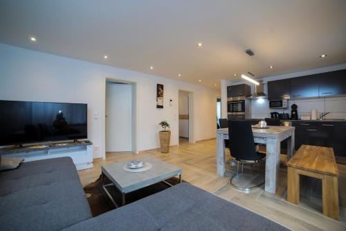 a living room and kitchen with a couch and a table at Apartment Claudia in Sinsheim