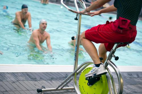 a man riding a bike in a swimming pool at Residence Carl&Do in Baveno
