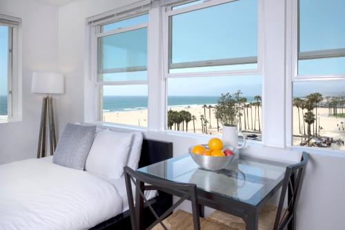 a living room with a couch and a table with a bowl of fruit at AIR Venice on the Beach in Los Angeles