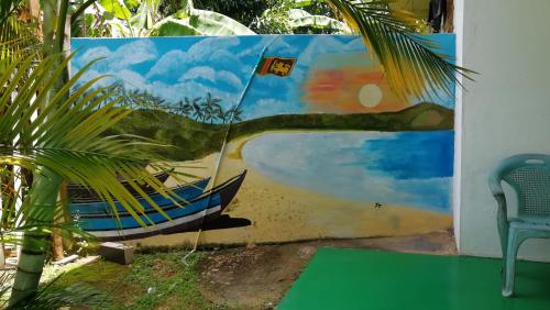 a painting of a boat on a wall at Thalalla BnB in Talalla