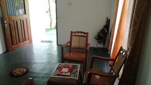a living room with two chairs and a christmas tree at Thalalla BnB in Talalla