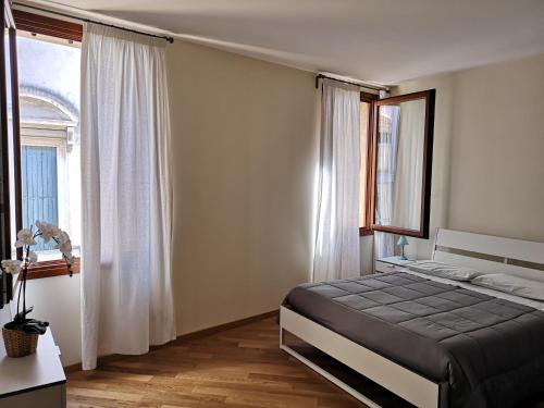 a bedroom with a large bed and a window at PATAVIUM APARTMENT in Padova