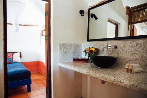 
a sink and a mirror in a room at Zamas Hotel in Tulum
