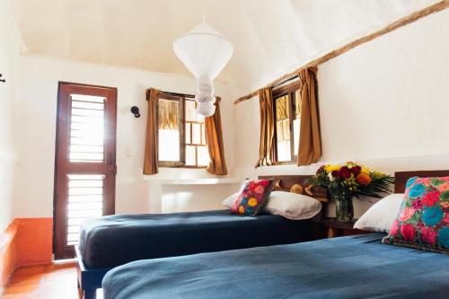 
a bedroom with two beds and two lamps at Zamas Hotel in Tulum
