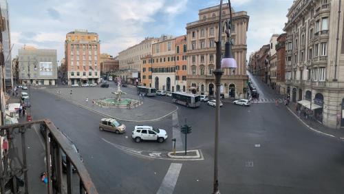 a city street with cars driving on a street with buildings at Pied a Terre Barberini in Rome