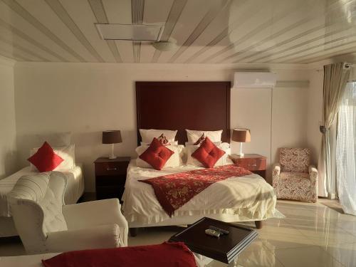 a bedroom with a large bed with red pillows at Dudsk Bed & Breakfast in Newcastle