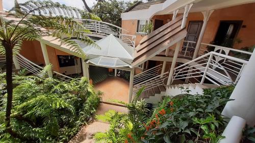 an external view of a building with stairs and plants at Hotel Ciudad Vieja in Guatemala