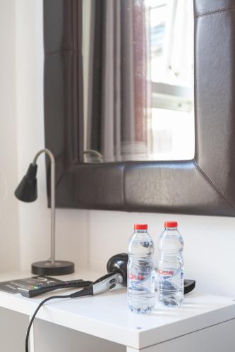 two bottles of water sitting on top of a counter at Eurovilla in Belfast