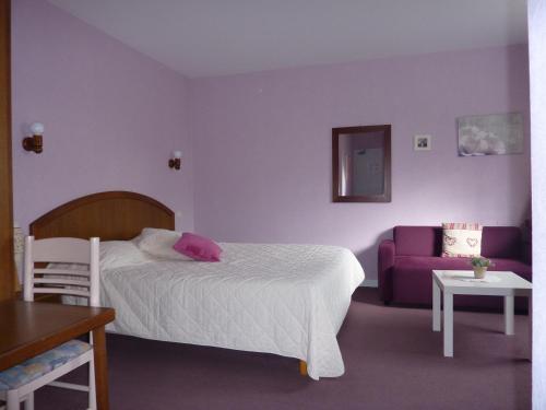 Ένα ή περισσότερα κρεβάτια σε δωμάτιο στο Hôtel A La Renommée