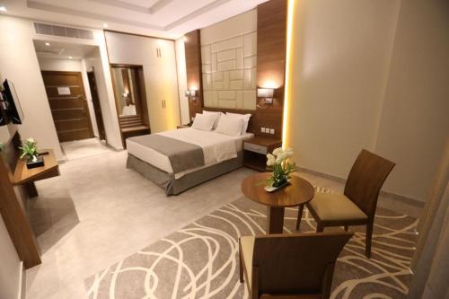 a hotel room with a bed and a table at Diamond Tower Hotel in Jeddah
