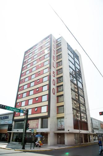 a tall building on a street corner with at Booking 500 in Monterrey
