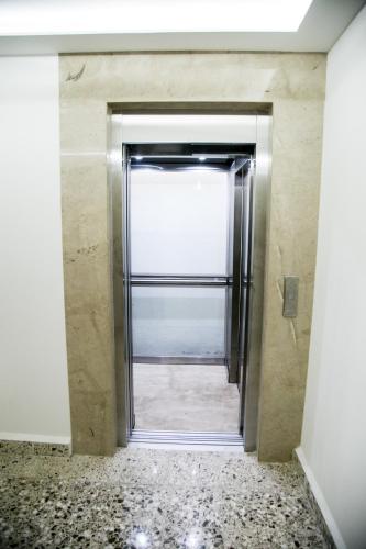 an elevator door in a room with a window at Booking 500 in Monterrey